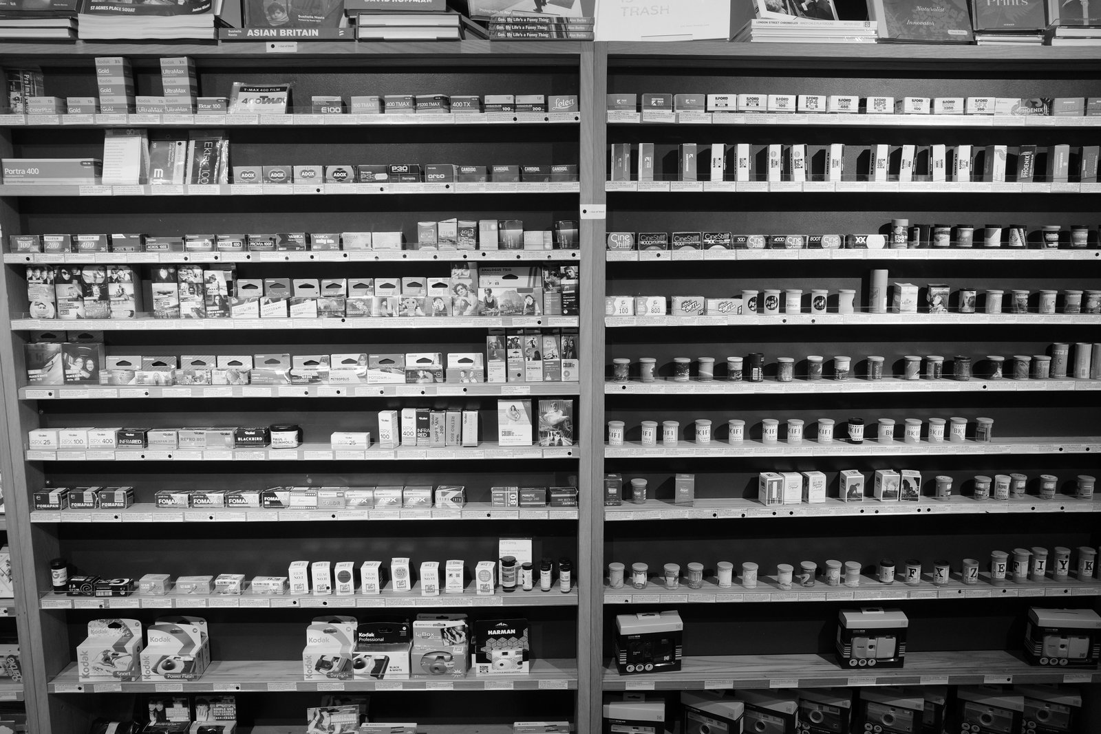 Rows of film boxes fill the shelves of a shop.