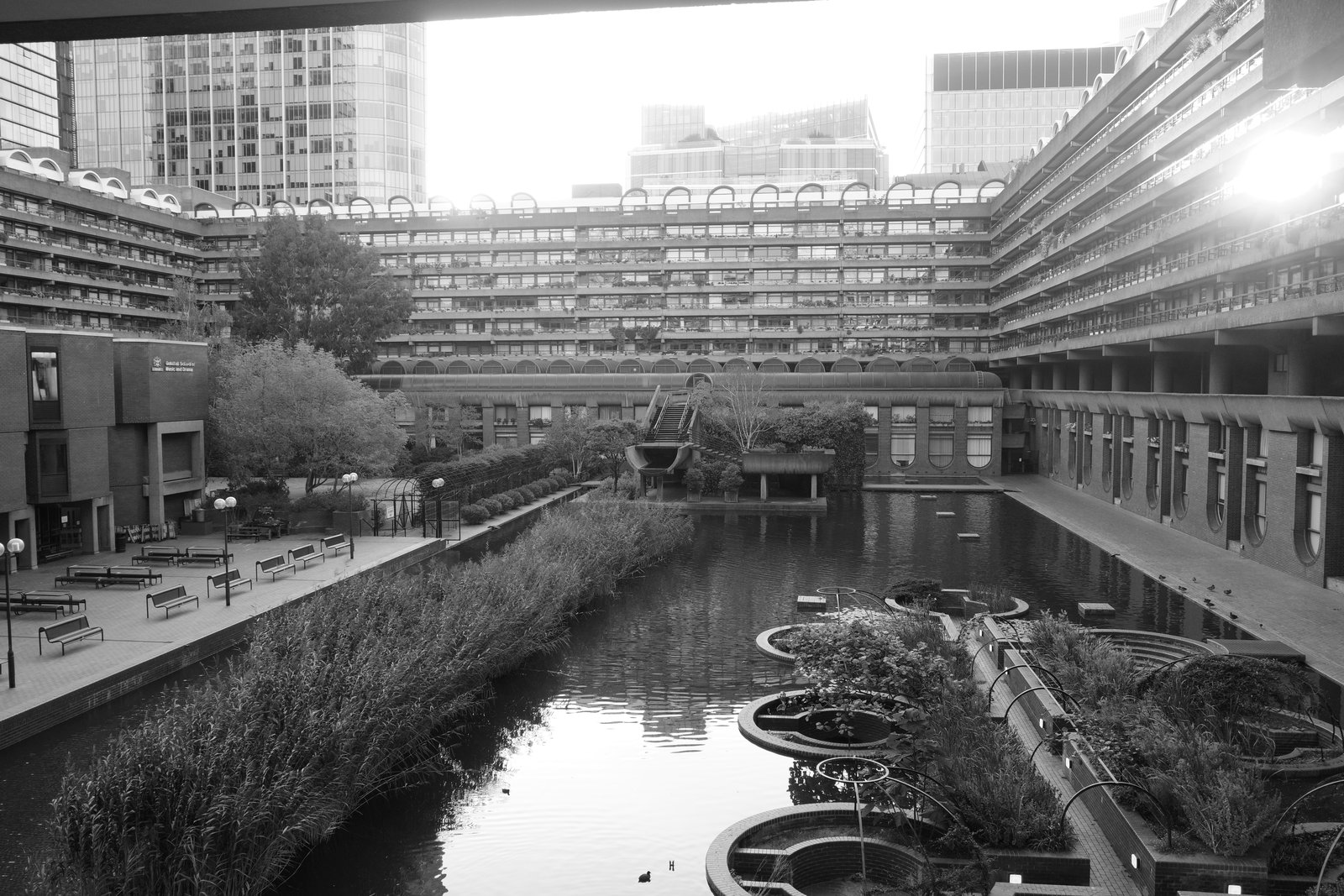 Water fills a courtyard surrounded by repeated balconies.
