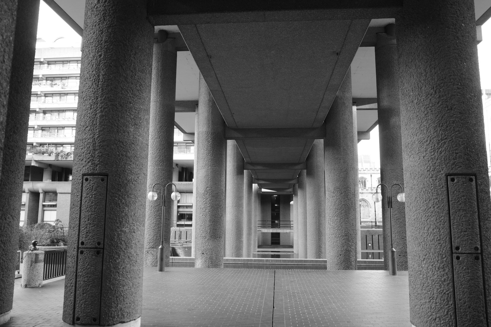 Concrete columns recede along a covered walkway.
