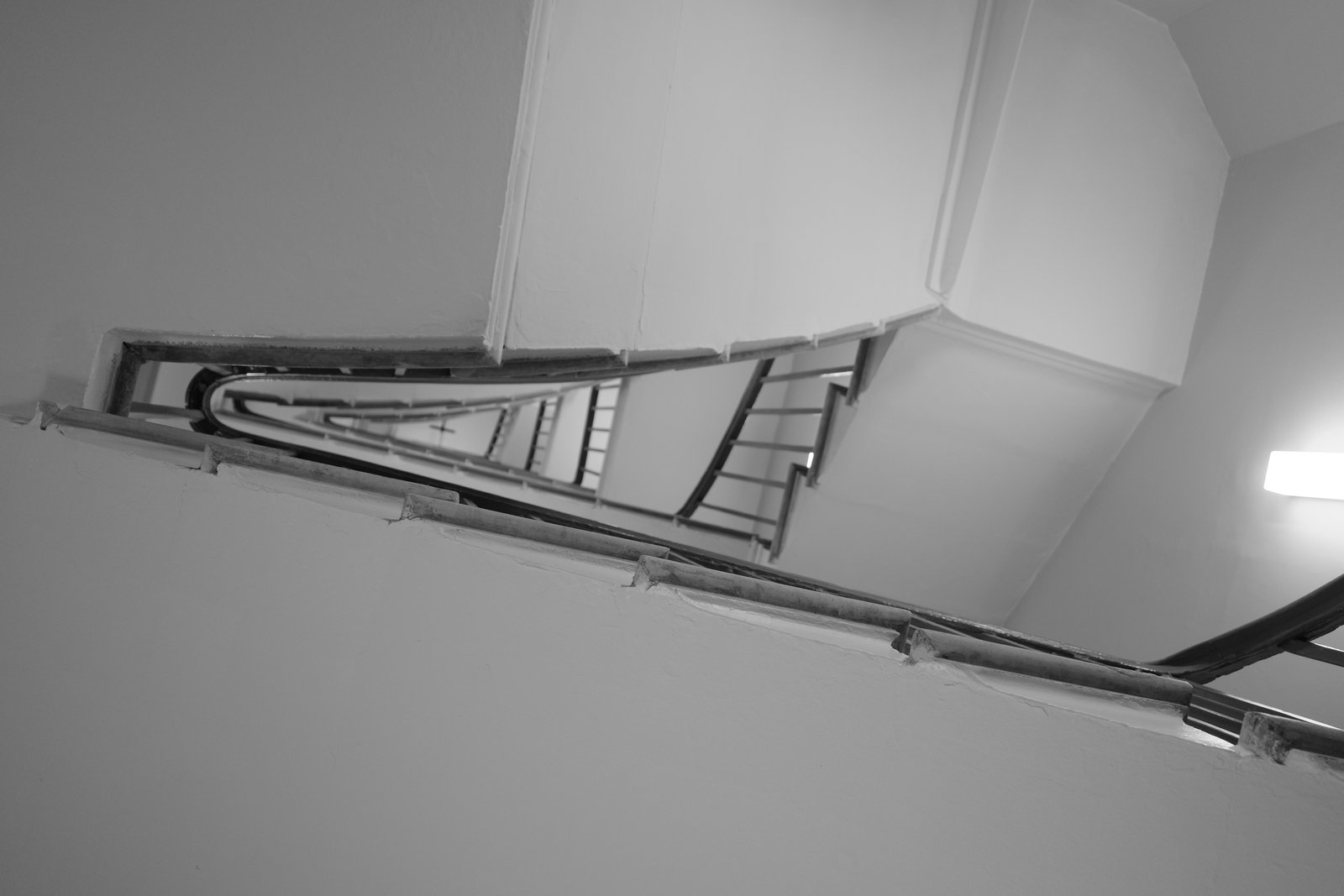 Narrow stair flights surround a triangular opening.