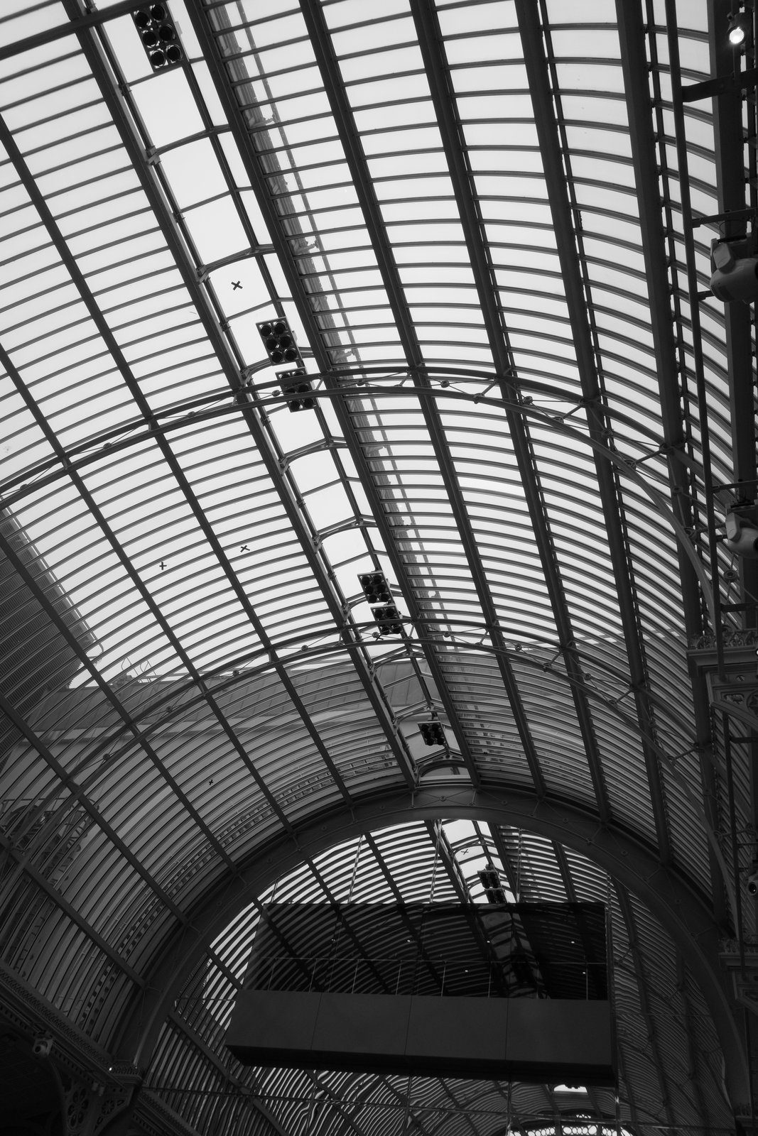 Ribs repeat through the curved glazing of a large roof.
