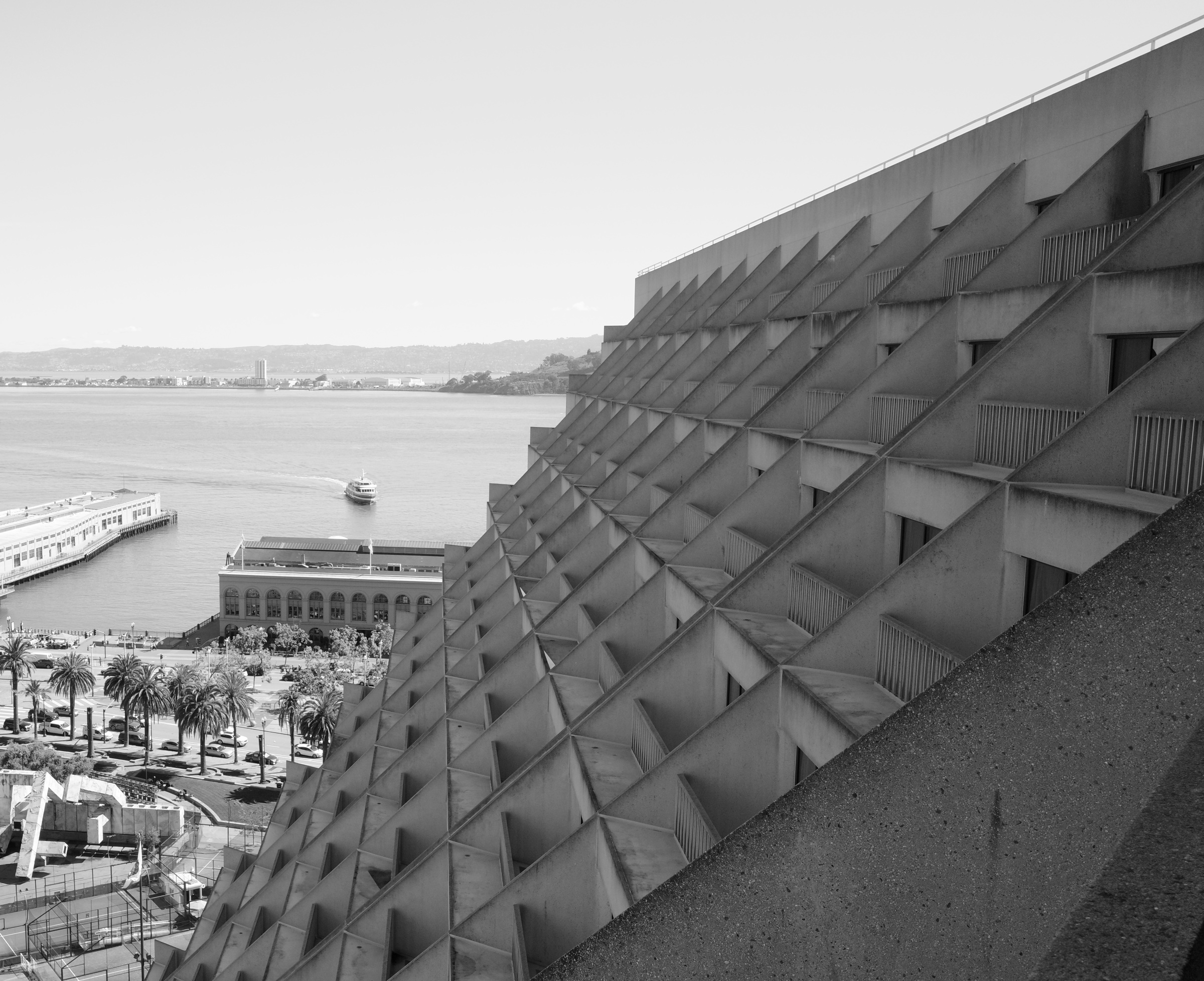 Concrete terraces descend toward open water.